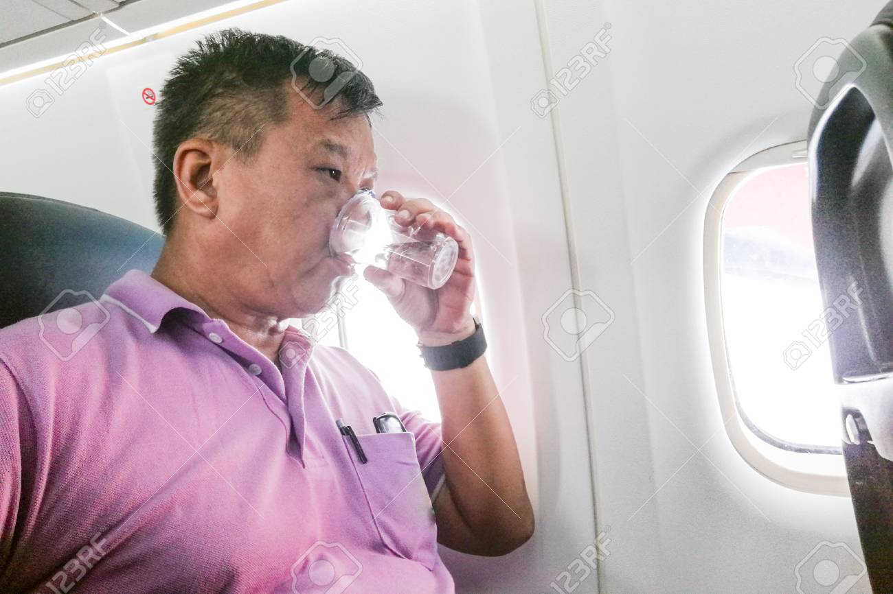 Person Drinking Water In Airplane Long Haul Flight To Hydrate.. Stock Photo, Picture And Royalty Free Image. Image 86873200.