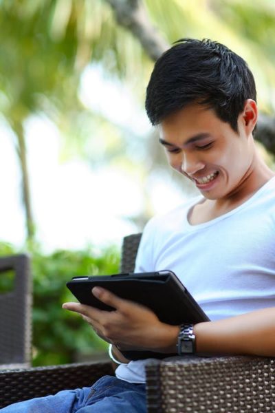Man in White Shirt Using Tablet Computer Shallow Focus Photography
